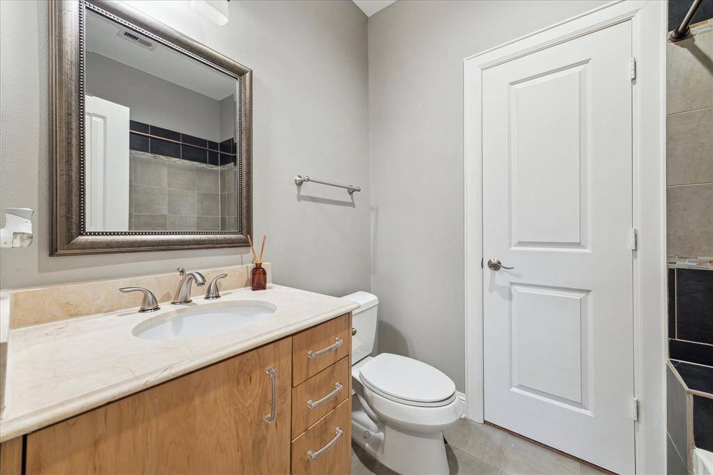 First floor: One of the downstairs bedrooms features a full en suite bath, beautifully maintained and in excellent condition. That door leads to the spacious walk-in closet,