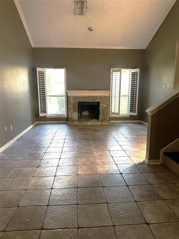 Spacious living room with high ceilings and fireplace