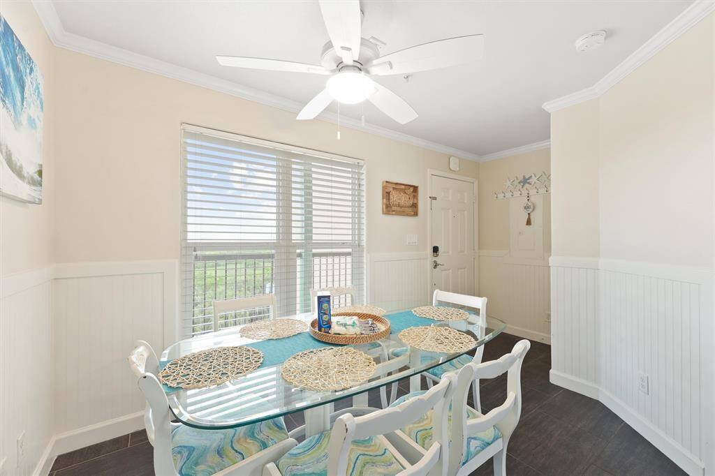 The charming dining nook is surrounded by natural light and features a coastal color palette ideal for island living.