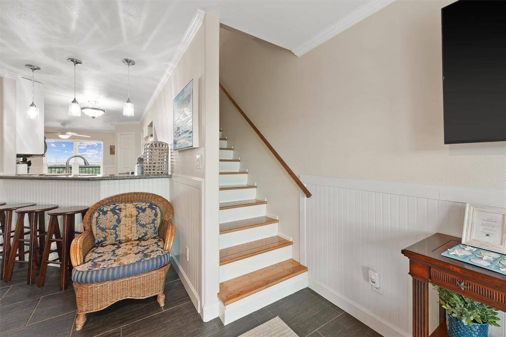 A coastal touch accents the staircase, which adds flexibility to this multi-level condo with a light and airy feel.