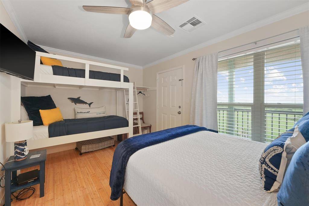 This thoughtfully designed guest bedroom features a queen bed and custom bunk beds—perfect for hosting family and friends.