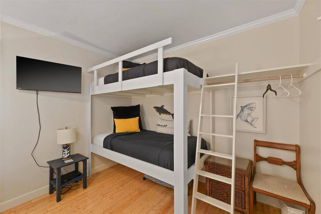 The custom-built bunk beds offer a fun, space-saving sleeping option with convenient built-in storage.