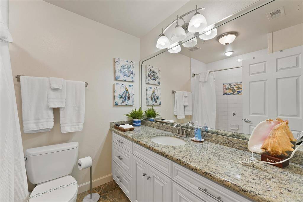 This spacious primary retreat leads seamlessly into the hallway and features warm wood flooring and fresh finishes.