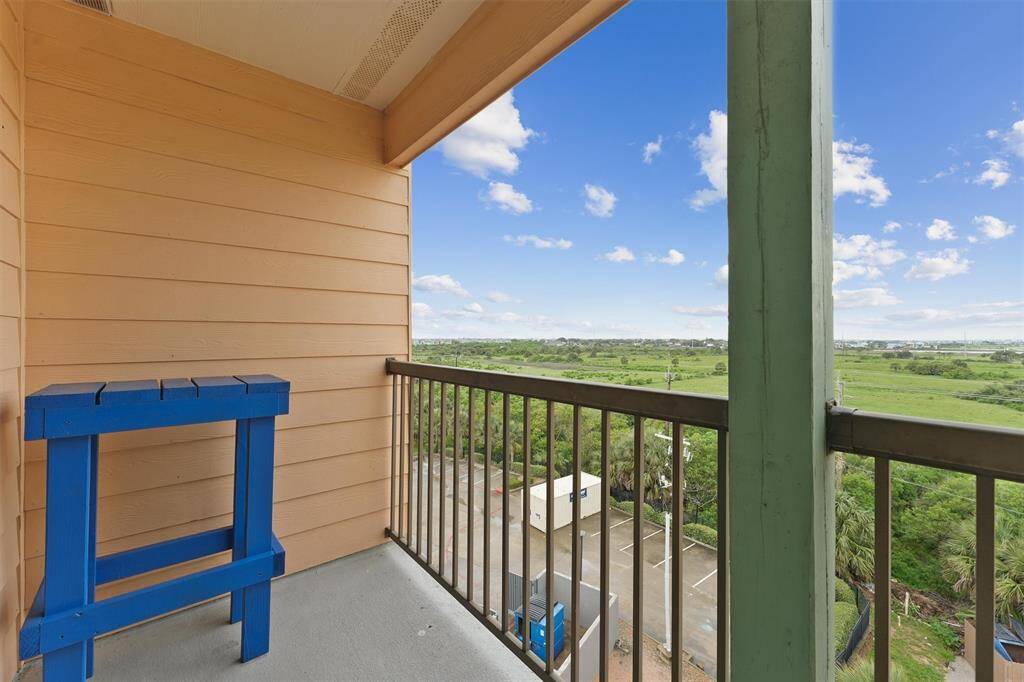 Enjoy peaceful views of the lush green space from the back balcony.