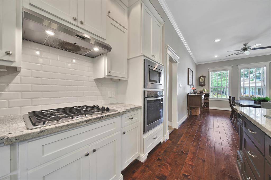 Functional kitchen space features updated appliances, gas stove, plenty of storage.