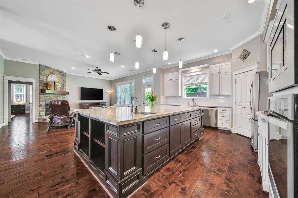 Functional kitchen space features updated appliances, gas stove, plenty of storage.