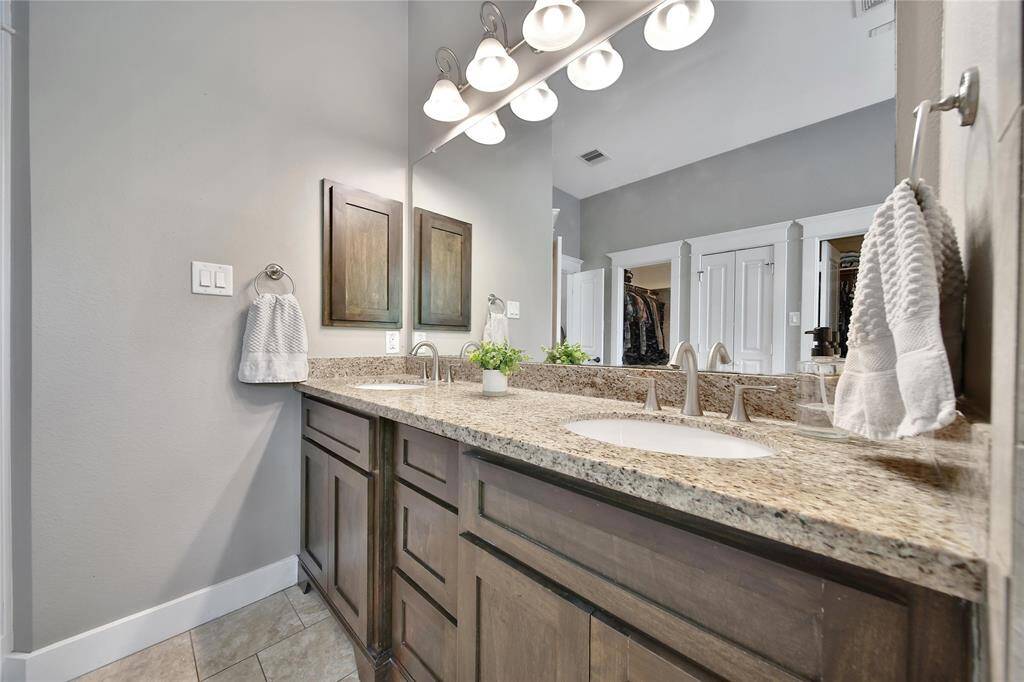 Primary bathroom features glass shower, soaking tub, double vanities, and two walk in closets.