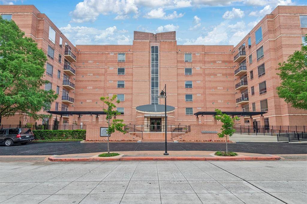 Grand elevation with secure building access via key fob or intercom, 2 assigned garage parking spots, and gated visitor parking.