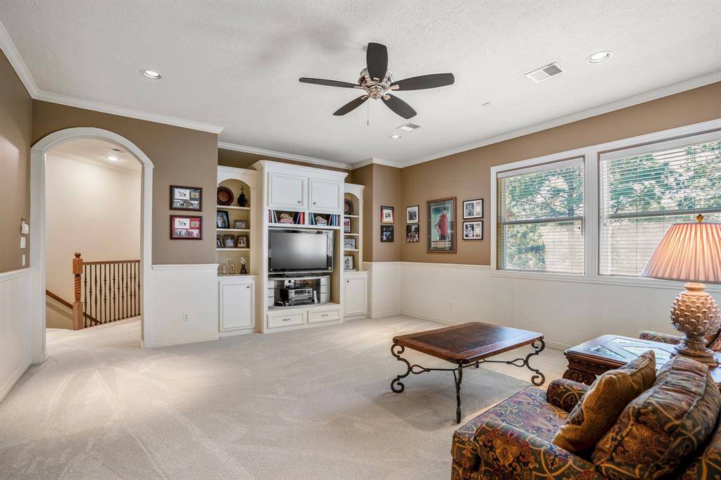 The gameroom upstairs offers a huge space for all your entertainment needs.  As well as custom built-ins and large windows.