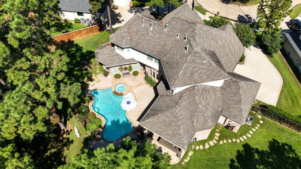 An aerial view of the pool and the home, showing how strategically placed the landscaping, pool and paths are, creating a wonderful place to live and enjoy.