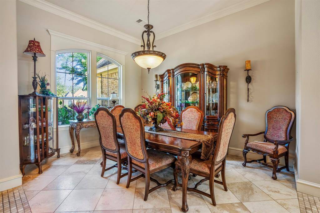 The elegant dining room is large enough to oversized furniture and is light and bright with detailed crown molding surrounding the windows.
