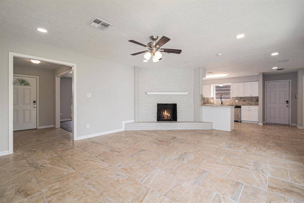 Here is your view of the kitchen from the far side of the living room. The entryway is to your left.