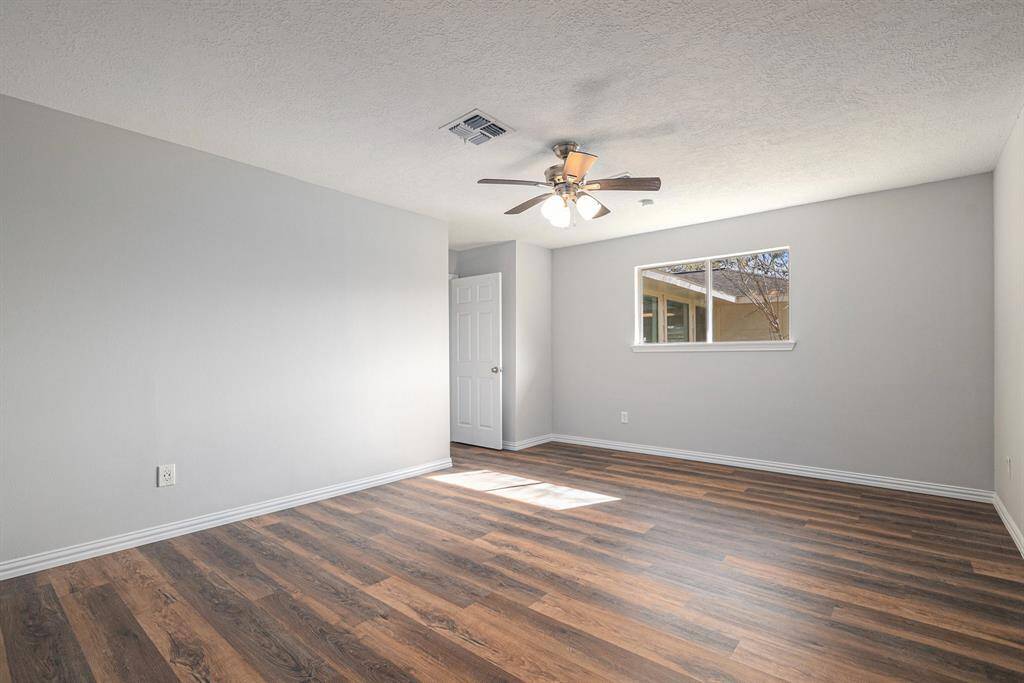 Stepping into the primary bedroom you'll be greeted with modern luxury vinyl plank flooring and a bright open feel.