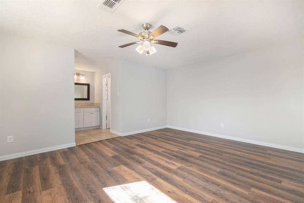 This view shows your access to the vanity, walk-in closet, and primary en-suite bath.