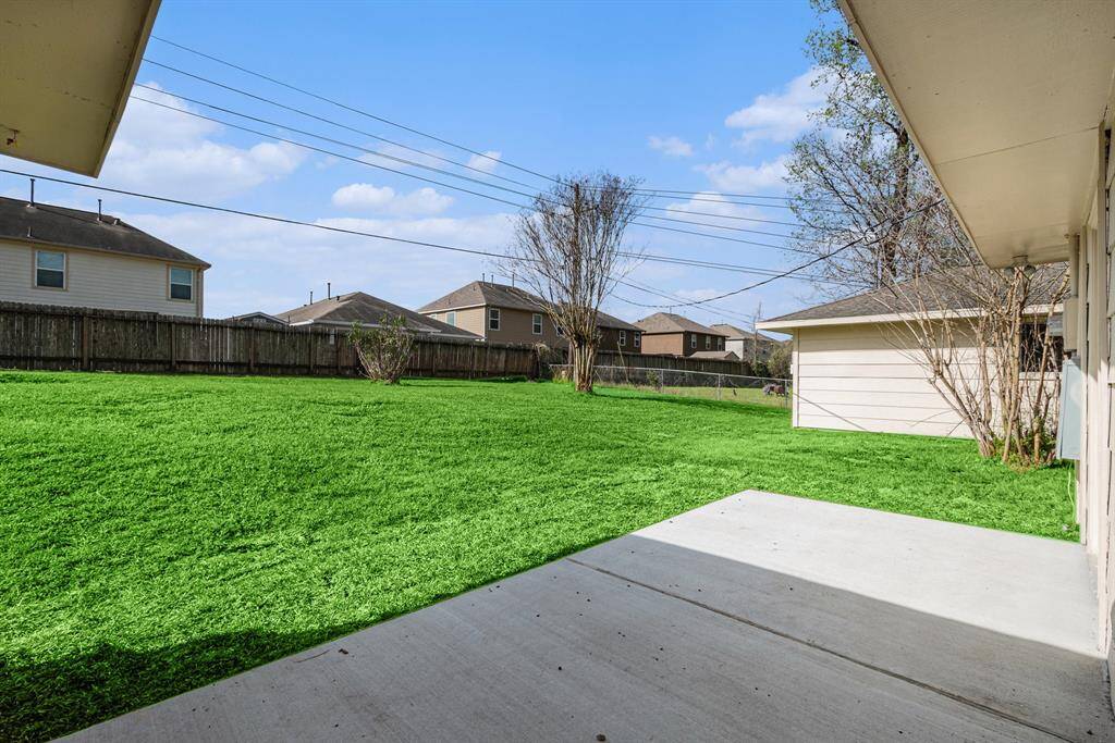 Let's step outside to your large backyard complete with French drains and patio.