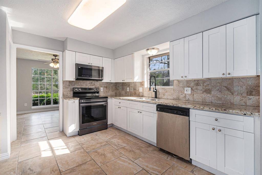 Your open-concept kitchen awaits! Complete with a Samsung microwave and oven, and Kenmore dishwasher.