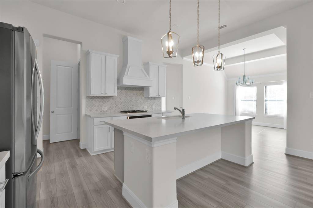 The kitchen is functional and offers an abundance of cabinet and counter space, as well as an expansive walk in pantry