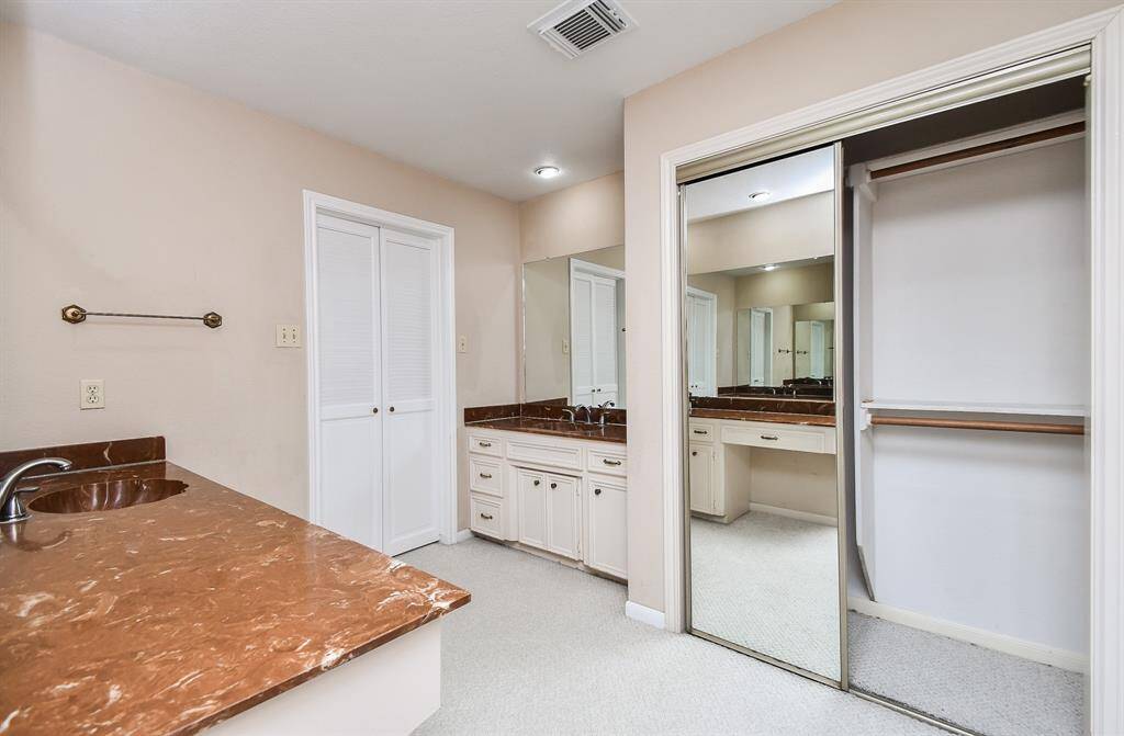 The primary bath is configured to give you two separate vanity areas and separate closets.