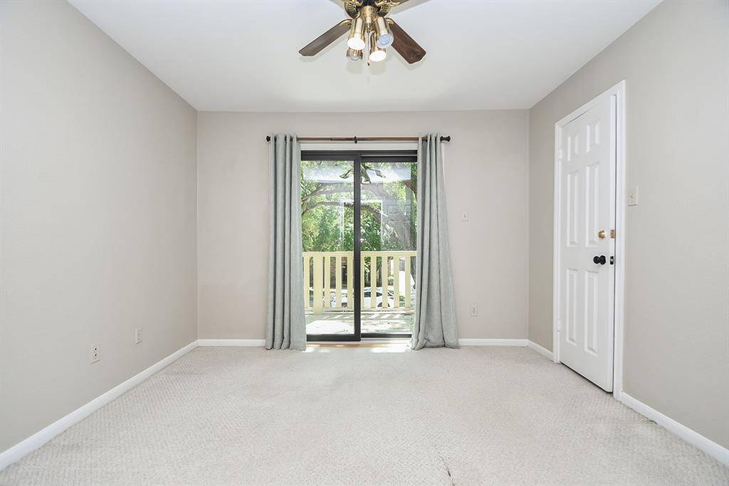 This bedroom leads out to a front facing balcony.