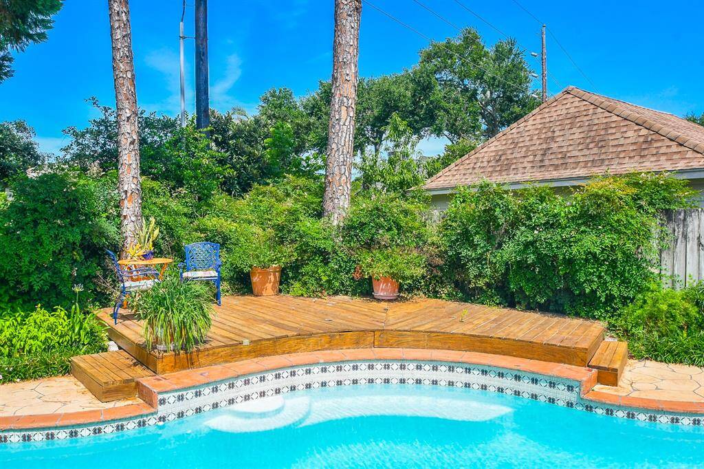 The showpiece of this home is definitely the pool and backyard deck.  The pool is inviting with the deck overlooking it and the landscaping is just gorgeous!