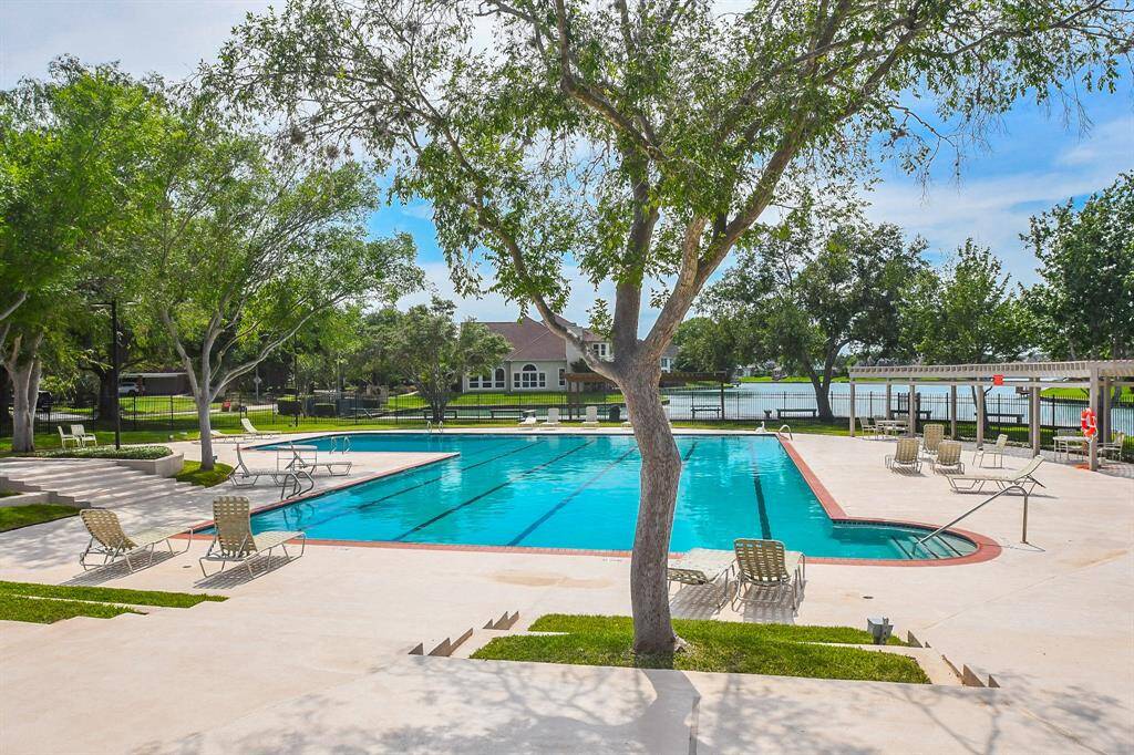 The neighborhood pool, adjacent to the lake creates a beautiful setting in this small, lovely neighborhood.