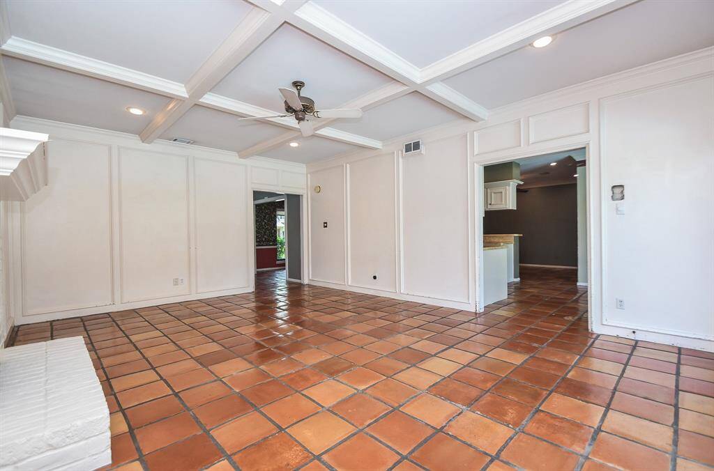 This view of the family room into the kitchen also highlights the saltillo tile throughout the downstairs.