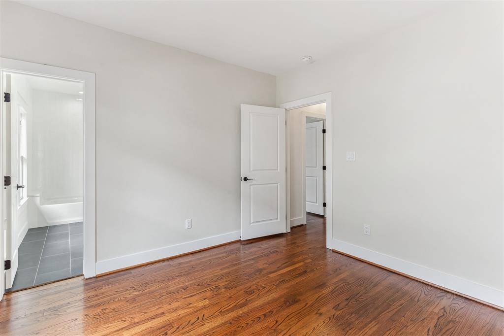 3rd bedroom w/ custom built in desk & shelving nook, also has access to the secondary full bathroom.