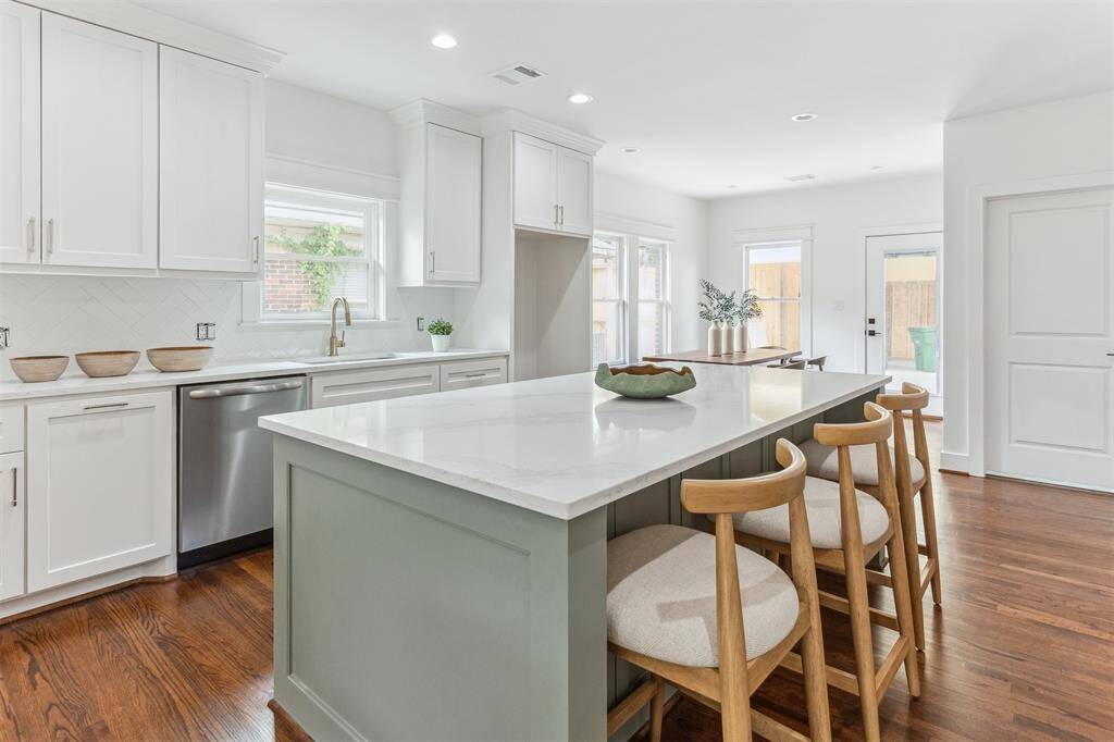 Notice the island has a wine fridge, microwave & extra storage.