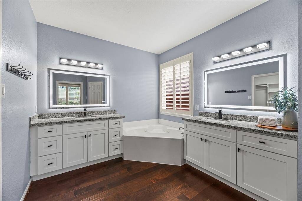 Exquisitely finished, the primary bedroom en suite has dual sinks and tons of storage cabinetry for self-care items. Each partner may easily get ready in the morning with ease and comfort.
