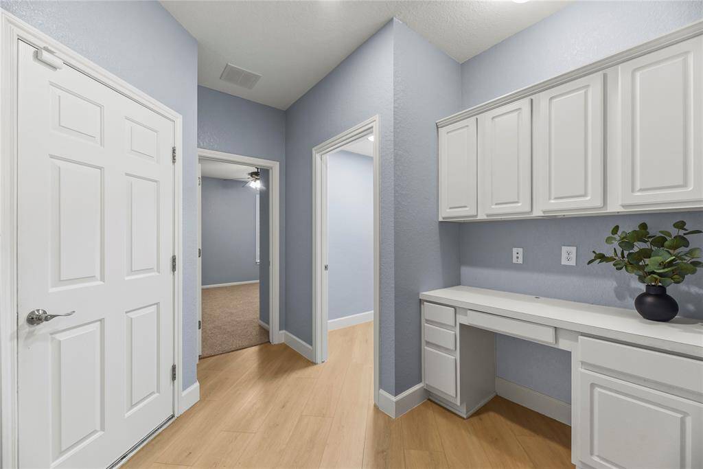 Operating a home office, doing homework, or managing household accounts may be easily accomplished with the custom built-in desks and cabinetry.