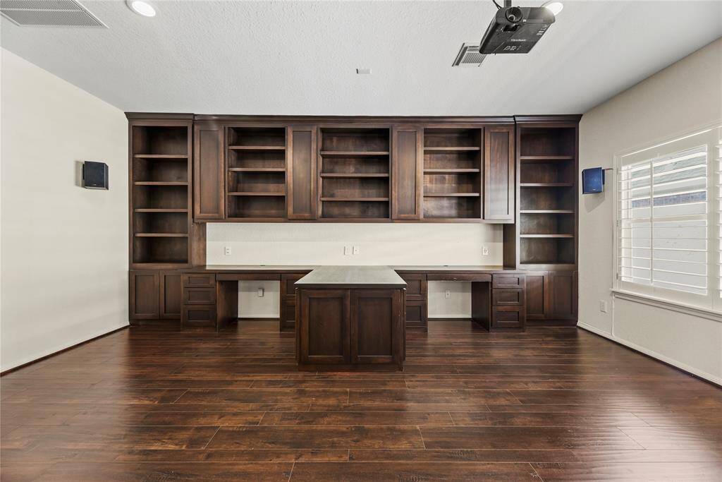 Custom built-in cabinet and desk setup in the home theater, ideal for a comfortable and efficient home office.