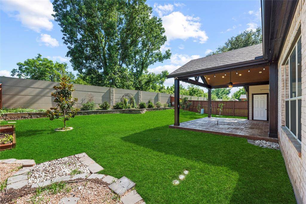 Lush emerald grass, deep mocha hued mulch, and vibrantly colored flowers cascade in a vivid array of outdoor beauty in the magnificent backyard! Complete with a comprehensive sprinkler system, the yard consistently receives the proper care and attention needed to maintain optimum grace.