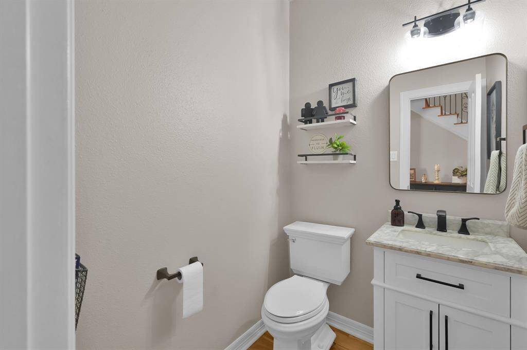 A quaint half bath lined with luxury
