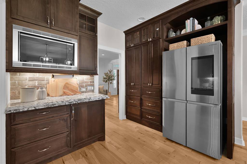 Stainless steel appliances wrap the chefs kitchen