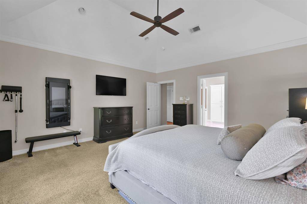 The primary bedroom with tall ceilings is attached to a tranquil ensuite sure to impress