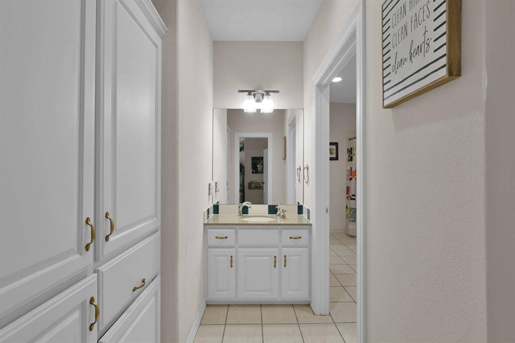 The Jack/Jill bathroom features ample storage, dual sinks and large shower/tub combo.