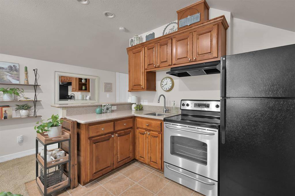Custom cabinetry and stainless steel appliances are all the jazz in this garage apartment