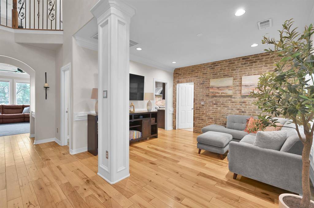 The large dining room can be used as a second living room, look at that gorgeous brick wall