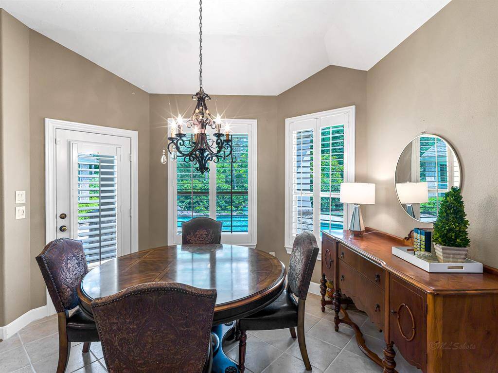 There’s ample space to comfortably accommodate a large dining table, making this area ideal for casual meals or family gatherings. Enjoy the ease of indoor-outdoor living with direct access to the covered patio, perfect for dining al fresco while taking in serene views of the sparkling pool and backyard oasis.