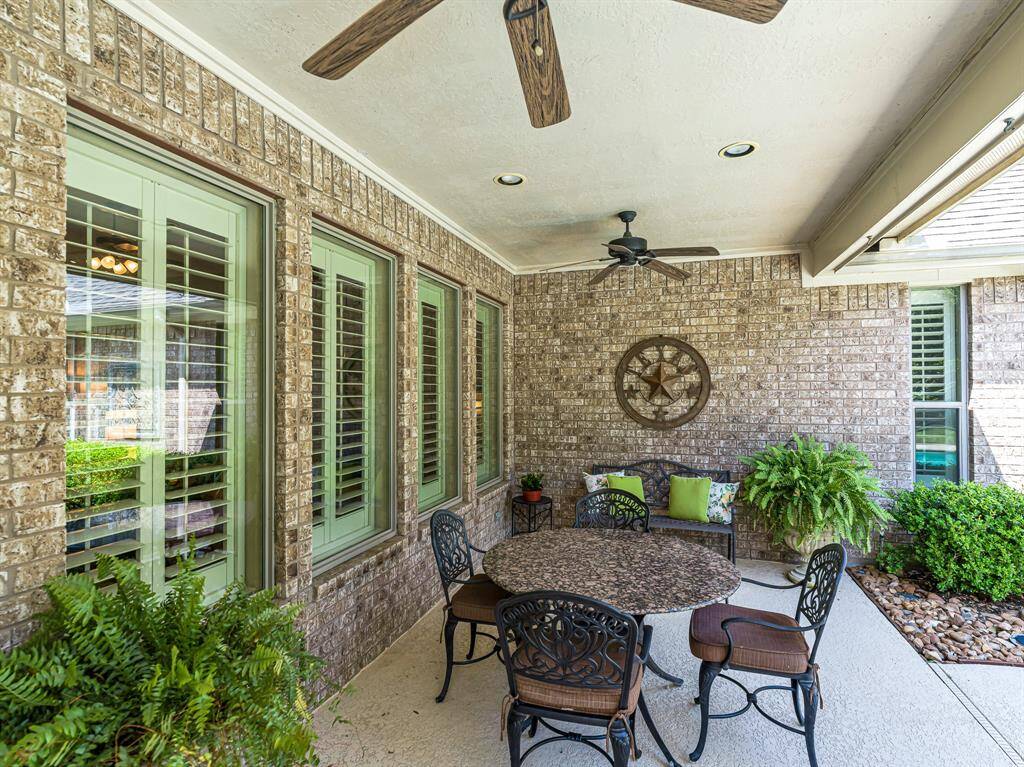 The backyard offers a true retreat, featuring a spacious covered patio with ceiling fans for year-round comfort. This inviting outdoor space is perfect for relaxing or entertaining, whether you're enjoying a quiet evening or hosting friends and family.