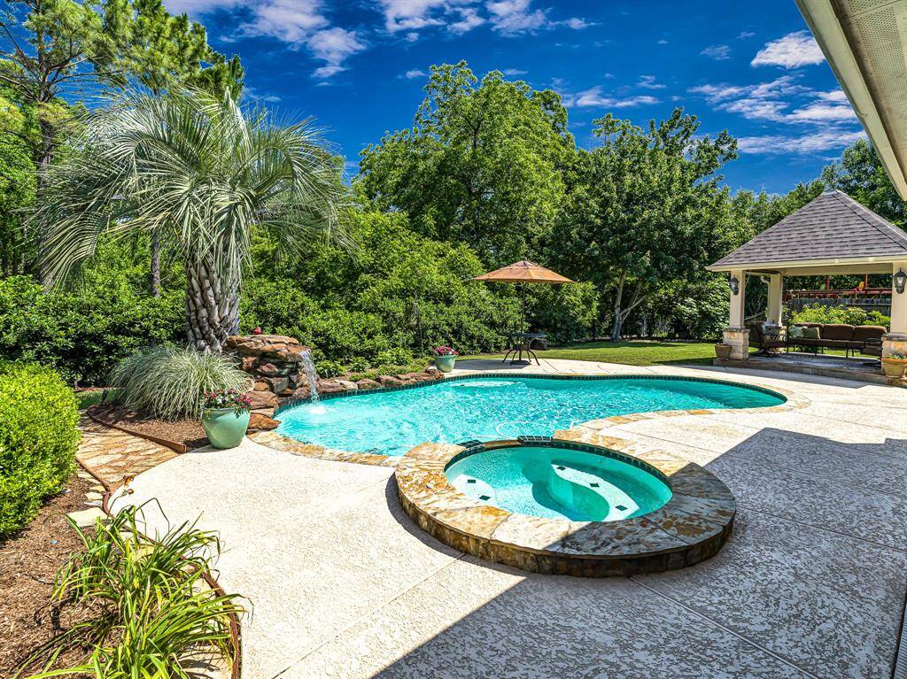 From the patio, you can enjoy sweeping views of the backyard oasis, which includes a sparkling pool, spa, lush landscaping, and serene surroundings, creating a peaceful and private haven just outside your door.