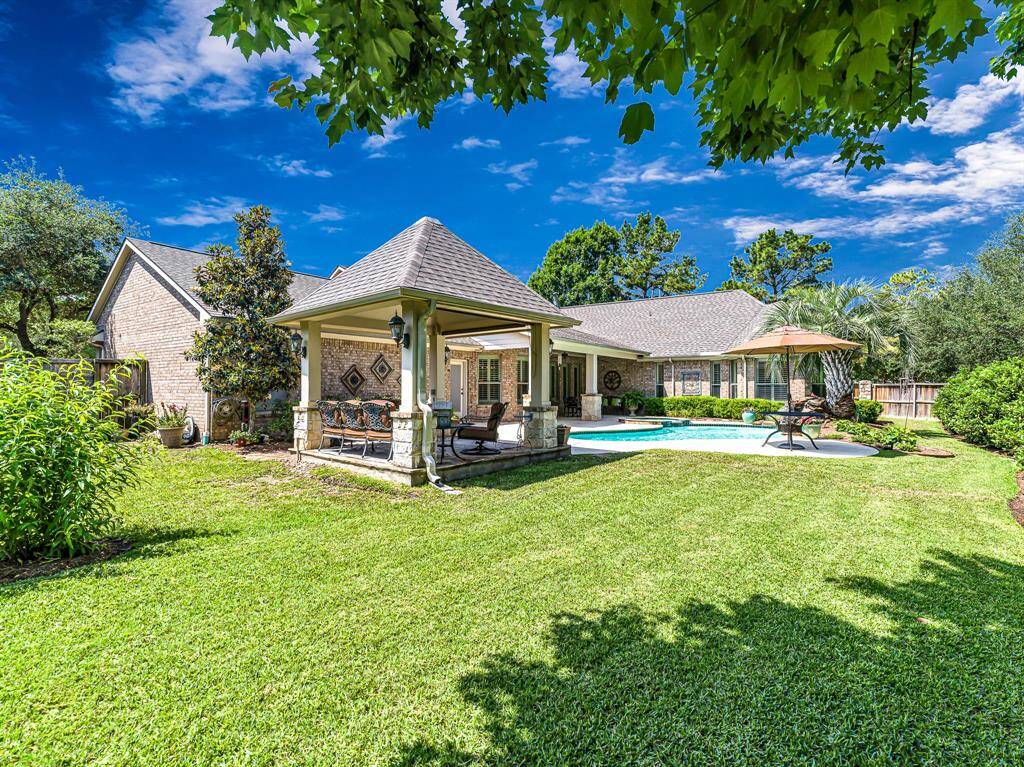 Ample green space surrounds the pool, offering plenty of room for pets and kids to play freely. The home is thoughtfully designed with brick and gutters on all four sides, ensuring durability and easy maintenance.