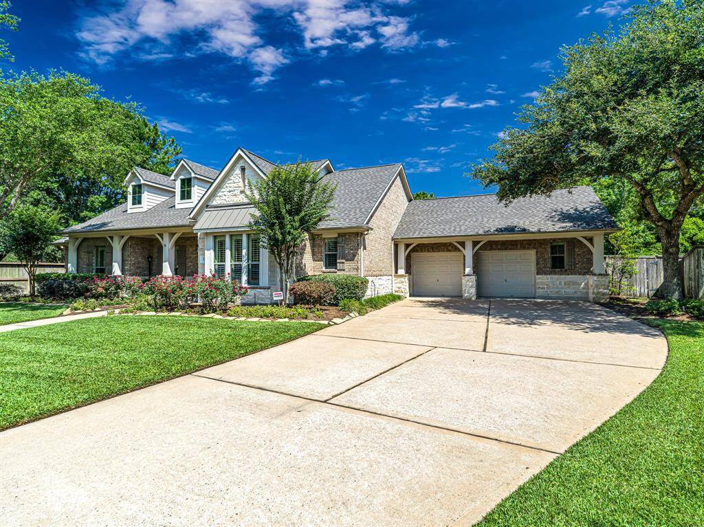 The extra-wide driveway provides ample parking space and leads directly to the convenient attached garage, offering easy access and plenty of room for vehicles.