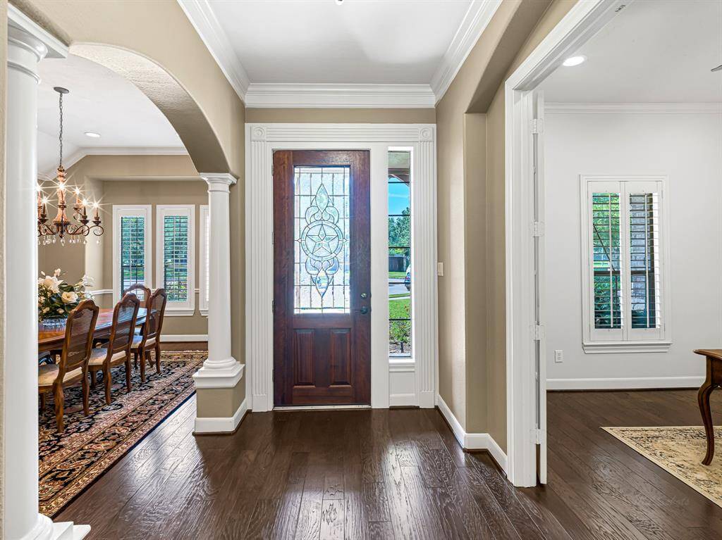 As you enter through the elegant 8-foot front door with a leaded glass window, you're welcomed into a warm and inviting interior that exudes both comfort and style. A sidelight window bathes the space in natural light, enhancing the airy, welcoming atmosphere.