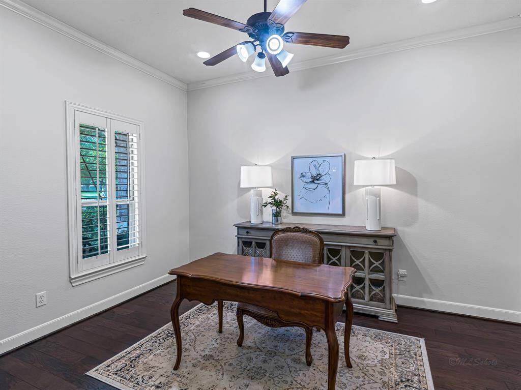 Tucked behind elegant glass French doors, the dedicated home office offers both privacy and style—ideal for remote work, study, or creative pursuits.  Recessed lighting provides clean, modern illumination, while a large window fitted with plantation shutters fills the room with natural light when desired.