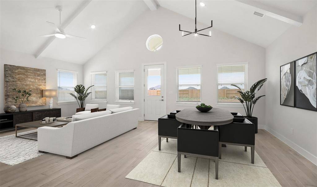 Impressive great room and dining area with high vaulted ceilings (*Photo not of actual home and used for illustration purposes only.)