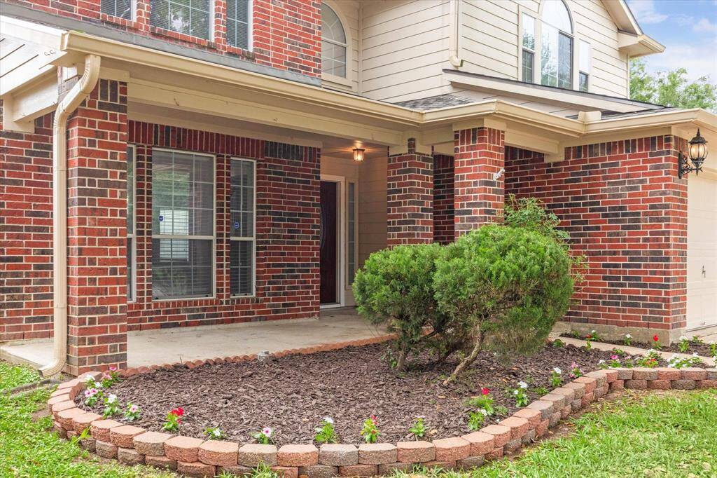 Freshly updated landscaping with beds and flowers.