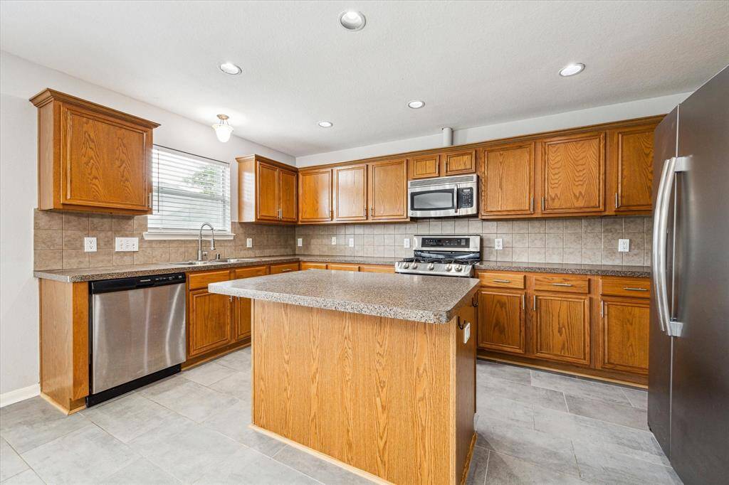 The kitchen has stainless steel appliances.