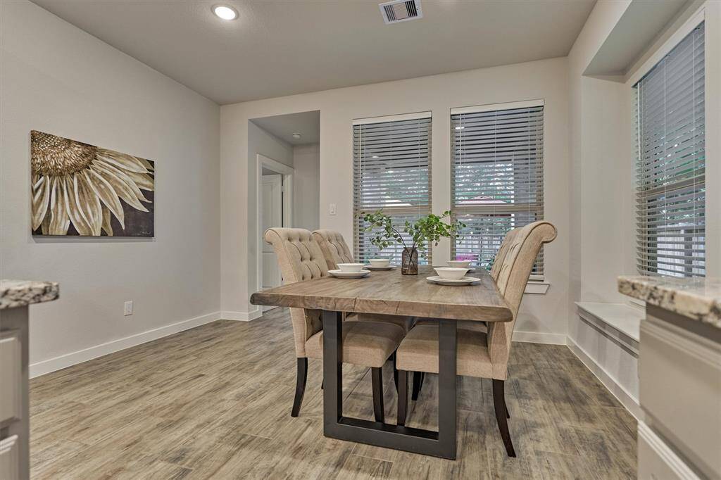 Open Concept Breakfast/Dining Room looking out to the lush backyard