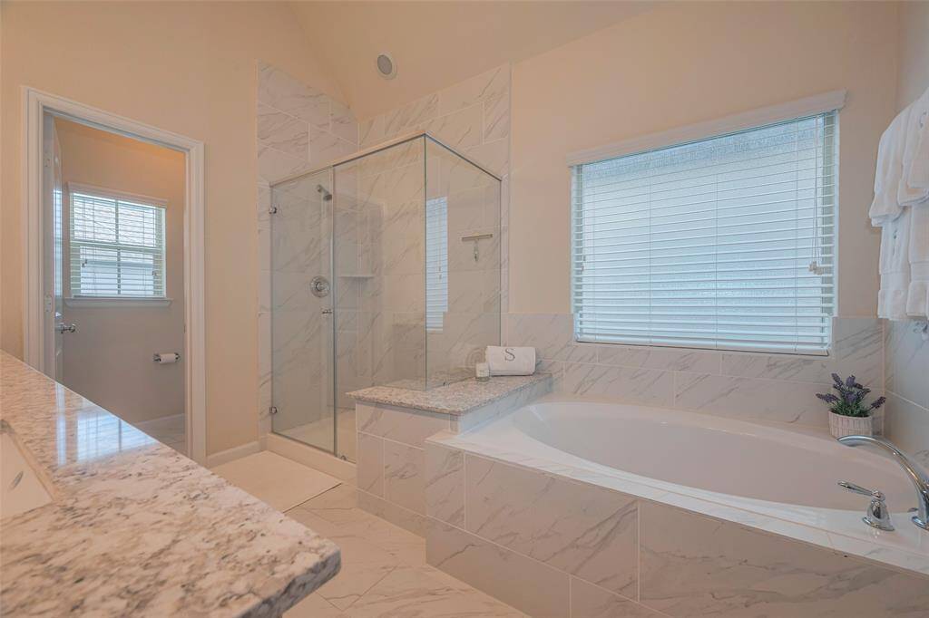Primary bathroom with soaking tub, stand alone shower and separate water closet